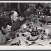 Lunch hour at one of the farms of the Woodman Potato Company. All of the pickers and field laborers eat in this converted toolhouse. Eleven miles north of Caribou, Maine.