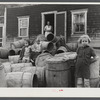 Children of Baptiste Deprui, French-Canadian potato farmer. He runs a small seed foundation unit and also raises some certified seed oats. The barrels in front of the house were left there after he had stored all the potatoes in the cellar of the house.