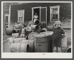 Children of Baptiste Deprui, French-Canadian potato farmer. He runs a small seed foundation unit and also raises some certified seed oats. The barrels in front of the house were left there after he had stored all the potatoes in the cellar of the house.
