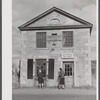 Young girl washing windows of post office in Old Mystic, Connecticut.
