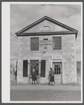 Young girl washing windows of post office in Old Mystic, Connecticut.
