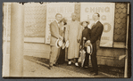 Harry Houdini, Bess Houdini, Ching Ling Foo, Chee Toy, and Tobias Bamberg (aka Okito) outside the Brighton Beach Music Hall, with promotional posters for Foo displayed behind