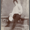 Adelaide Herrmann in costume for her bullet-catching trick and holding the plate used for the bullets