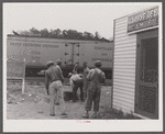 Florida migrants during lunch hour at potato grading station. Camden, North Carolina.