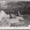 Migratory agricultural worker asleep in boxcar. Camden, North Carolina.