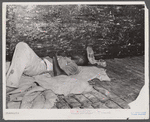 Migratory agricultural worker asleep in boxcar. Camden, North Carolina.