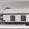 Warehouse that provides housing for a number of migratory agricultural workers. On the left is the baggage of some of the new arrivals. Camden, North Carolina.