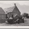 Part of a crew of thirty-five migrants who come up in this truck and who stay in the farmhouse in background. It is Sunday and they are going into town for the day.