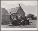 Part of a crew of thirty-five migrants who come up in this truck and who stay in the farmhouse in background. It is Sunday and they are going into town for the day.