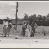 Migratory agricultural workers on Route 27 trying to "hitch" north with the potato season. North Carolina.