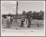 Migratory agricultural workers on Route 27 trying to "hitch" north with the potato season. North Carolina.