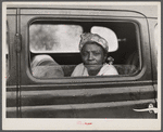 Migratory agricultural worker with seven others in the car on their way to Cranberry, New Jersey, for the potato season.