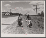 Migratory agricultural workers on Route 27 trying to "hitch" north with the potato season. North Carolina.