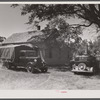 Florida migrants' truck and car outside of farmhouse that houses thirty-seven of them. Old Trap, North Carolina.