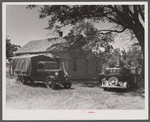 Florida migrants' truck and car outside of farmhouse that houses thirty-seven of them. Old Trap, North Carolina.