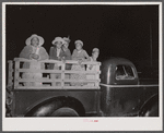 Group of migratory agricultural workers at the company store at Camden, North Carolina. They have just bought some provisions and are being taken out to their house in the fields.