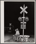 Migratory agricultural workers having supper at the railroad crossing at Camden, North Carolina.