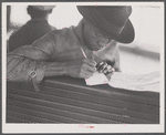 Migratory worker on the Norfolk-Cape Charles Ferry, writing a postcard home to his parents.