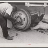 Repairing tire of a truck carrying thirty-five migratory agricultural workers from North Carolina to pick beans near Easton, Maryland.
