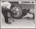 Repairing tire of a truck carrying thirty-five migratory agricultural workers from North Carolina to pick beans near Easton, Maryland.