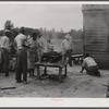 Over this stove, cooking is done for the thirty five migrants that stay in this house in the background. Near Old Trap, North Carolina.