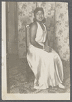 Teresa Roldan sits in long sleeveless dress
