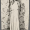 Teresa Roldan stands in long sleeveless dress