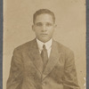 Man in suit and tie in studio portrait, undated