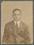 Man in suit and tie in studio portrait, undated