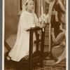 Child, dressed in white and kneeling, during First Communion
