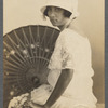 Lola Larrea in hat and lace dress in formal portait with parasol