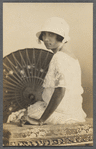 Lola Larrea in hat and lace dress in formal portait with parasol