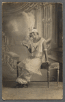 Young woman in feathered headgear and pearls in formal portrait