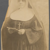 Sister M. Rose in eyeglasses and holding pamphlet