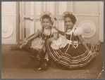 Margarita and Sonia in bric brac dresses in formal portrait