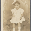 Teresa Roldan in hair bow and Mary Jane shoes in formal portrait