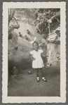 Teresa Roldan in hair bow and hand on hip in formal portrait
