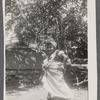 Teresa Roldan, in headwrap, stands with hand on hip