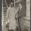 Harry Houdini with Ching Ling Foo outside the Brighton Beach Music Hall, with promotional poster behind