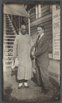 Harry Houdini with Ching Ling Foo outside the Brighton Beach Music Hall, with promotional poster behind