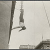 Harry Houdini suspended upside down from a building