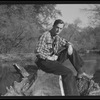 Roger Peterson seated on rock