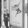 Arthur Mitchell outside the Metropolitan Opera house posing with poster publicizing the Dance Theatre of Harlem At the Met