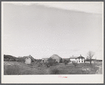 A long "strung out" farm house near Robbinston, Maine.