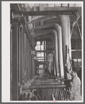 New type of plating machine being used at the Hamilton Standard Propeller Corporation. It automatically dips the part into the proper solutions for the proper length of time. East Hartford, Connecticut.