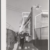 Workmen leaving the plant at Vought Sikorsky Aircraft Corporation. Stratford, Connecticut.