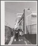 Workmen leaving the plant at Vought Sikorsky Aircraft Corporation. Stratford, Connecticut.