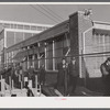 Workmen leaving the plant at the Vought Sikorsky Aircraft Corporation. Stratford, Connecticut.