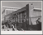 Workmen leaving the plant at the Vought Sikorsky Aircraft Corporation. Stratford, Connecticut.