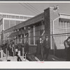 Workmen leaving the plant at the Vought Sikorsky Aircraft Corporation. Stratford, Connecticut.
